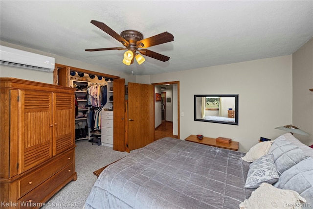 2637 E 7th Rd, Roscommon, MI 48653 - carpeted bedroom with a wall mounted AC, a spacious closet, ceiling fan, and a closet