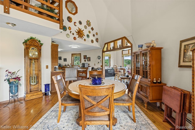 2637 E 7th Rd, Roscommon, MI 48653 - dining space featuring a towering ceiling and hardwood / wood-style flooring