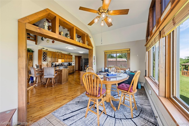 2637 E 7th Rd, Roscommon, MI 48653 - dining room featuring vaulted ceiling, ceiling fan, and light wood-style floors