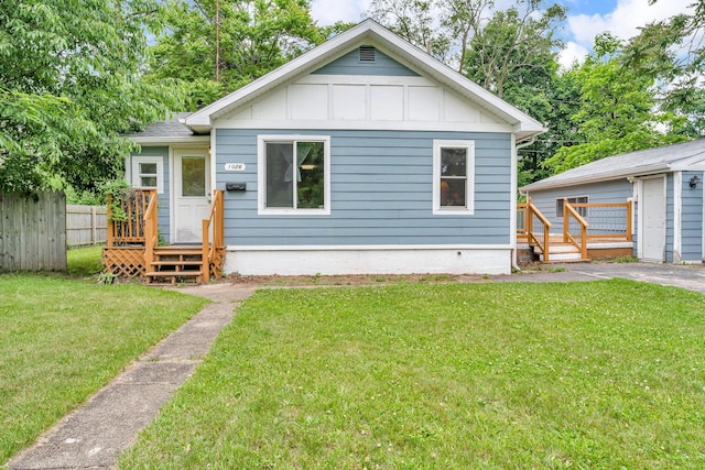 1026 Jennings Ave, Benton Harbor, MI 49022 - view of front facade with board and batten siding and a wooden deck