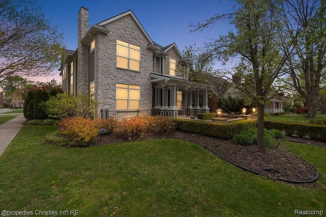 1419 Henrietta St, Birmingham, MI 48009 - view of front of house with stone siding, a yard, and a chimney