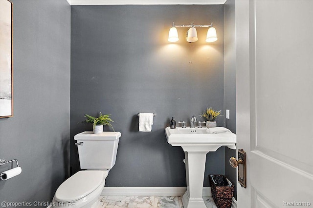 1419 Henrietta St, Birmingham, MI 48009 - half bathroom with toilet, marble look tiles, and baseboards