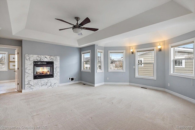 1419 Henrietta St, Birmingham, MI 48009 - unfurnished living room featuring a tray ceiling, light colored carpet, a ceiling fan, and a fireplace
