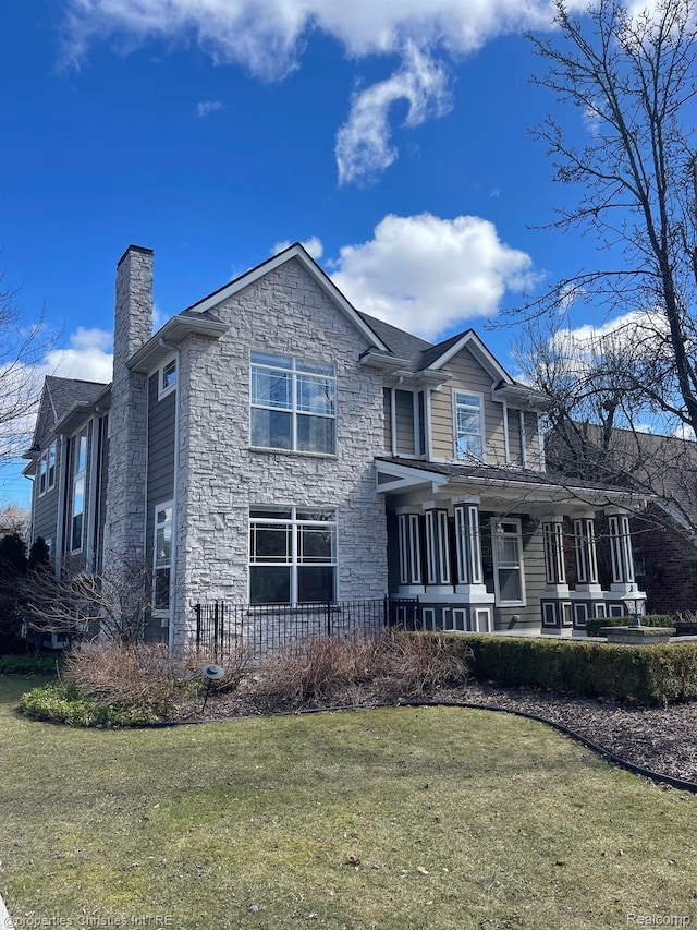 1419 Henrietta St, Birmingham, MI 48009 - view of front of property featuring stone siding, a chimney, a front yard, and a porch