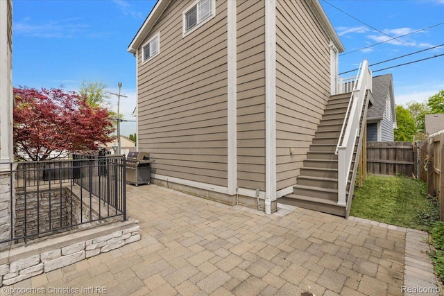 1419 Henrietta St, Birmingham, MI 48009 - fenced backyard featuring a patio, stairs, and a grill