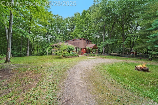 3030 Stanton Rd, Oxford, MI 48371 - view of dirt / gravel driveway featuring a forest view