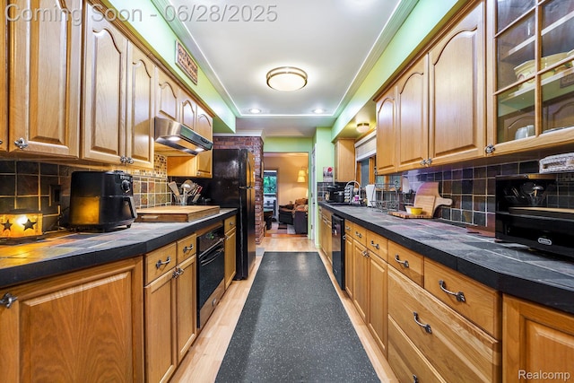3030 Stanton Rd, Oxford, MI 48371 - kitchen featuring black appliances, under cabinet range hood, tasteful backsplash, and glass insert cabinets