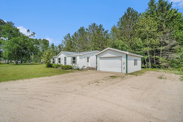 12342 N Mackinaw Hwy, Carp Lake, MI 49718 - manufactured / mobile home featuring a garage and a front yard