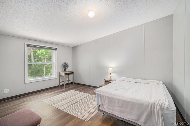 12342 N Mackinaw Hwy, Carp Lake, MI 49718 - bedroom with wood finished floors and a textured ceiling