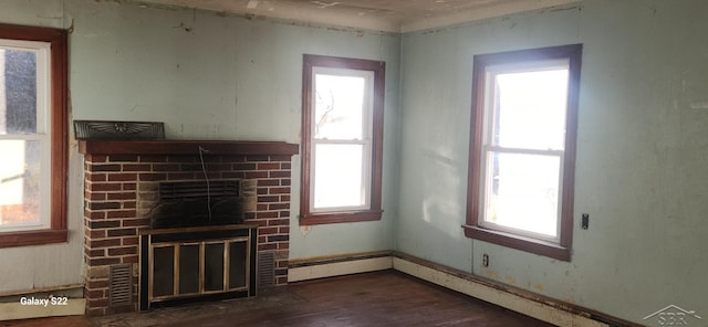 1701 Home Dr, Fairview, MI 48621 - unfurnished living room with a fireplace, wood finished floors, and baseboard heating
