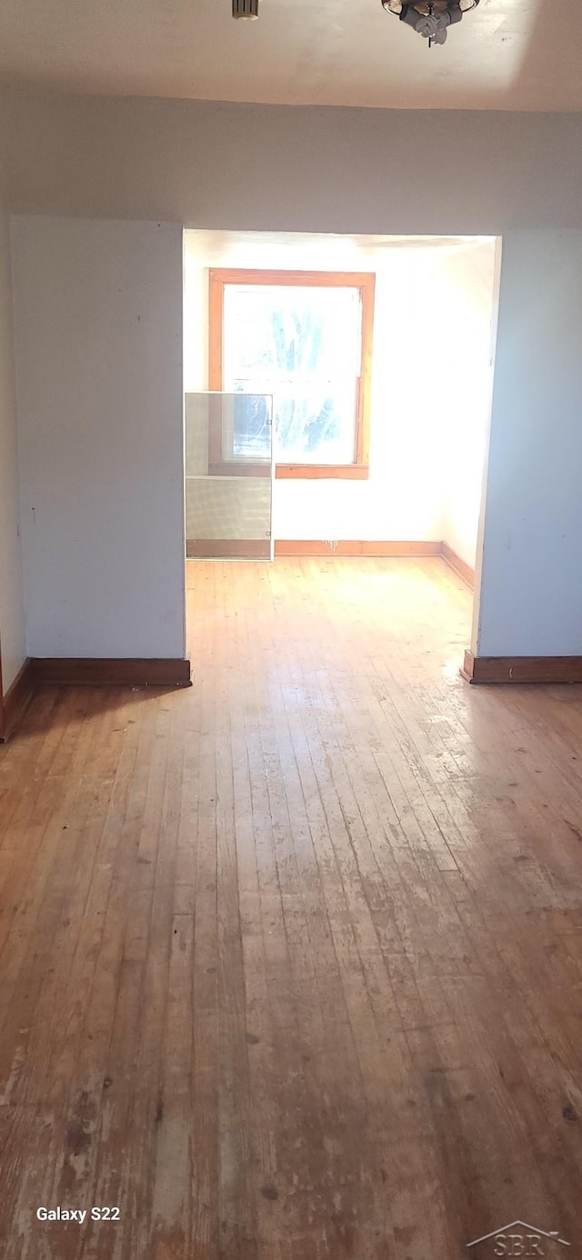 1701 Home Dr, Fairview, MI 48621 - empty room featuring wood-type flooring and baseboards