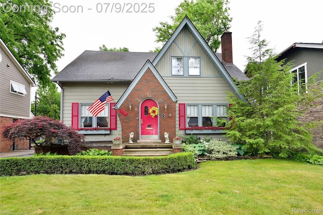 1719 Sycamore Ave, Royal Oak, MI 48073 - english style home featuring a front lawn, a chimney, brick siding, board and batten siding, and roof with shingles