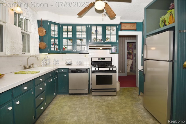 1719 Sycamore Ave, Royal Oak, MI 48073 - kitchen featuring appliances with stainless steel finishes, under cabinet range hood, ceiling fan, a textured ceiling, and decorative backsplash