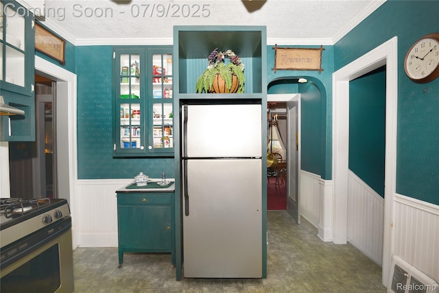 1719 Sycamore Ave, Royal Oak, MI 48073 - kitchen with freestanding refrigerator, gas stove, a textured ceiling, a wainscoted wall, and ornamental molding