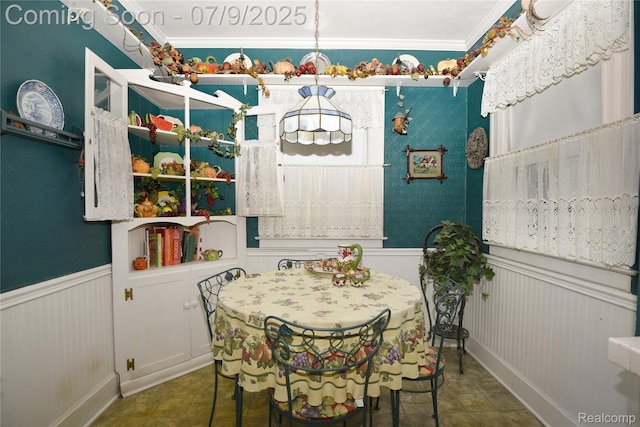 1719 Sycamore Ave, Royal Oak, MI 48073 - tiled dining area featuring wainscoting, ornamental molding, and a decorative wall