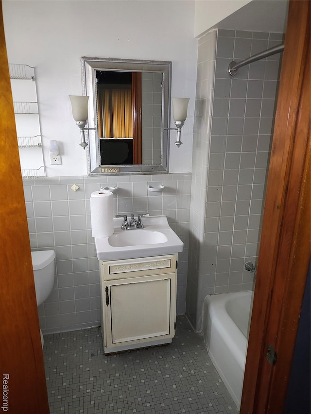 20456 Van Antwerp St W, Harper Woods, MI 48225 - full bathroom featuring vanity, tile walls, tile patterned flooring, and shower / tub combination
