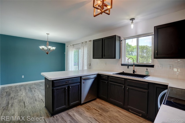 11468 Grand Oaks Dr, Clio, MI 48420 - kitchen with dishwasher, a sink, a chandelier, a peninsula, and plenty of natural light