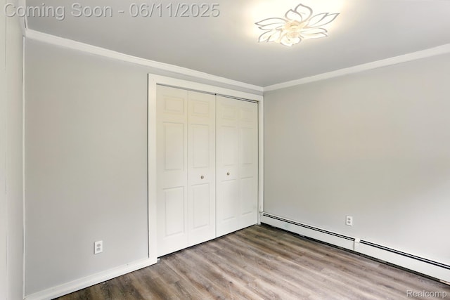 22521 Hoffman St, Saint Clair Shores, MI 48082 - unfurnished bedroom with wood finished floors, ornamental molding, a baseboard radiator, and a closet