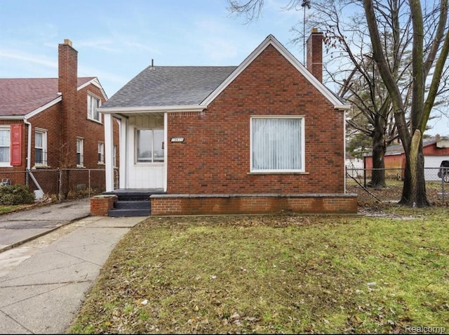19611 Revere St, Detroit, MI 48234 - bungalow featuring brick siding, a chimney, a shingled roof, and covered porch