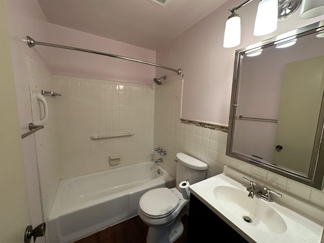 101 Provincial Ct, Saginaw, MI 48638 - full bathroom featuring shower / washtub combination, vanity, toilet, tile walls, and wood finished floors