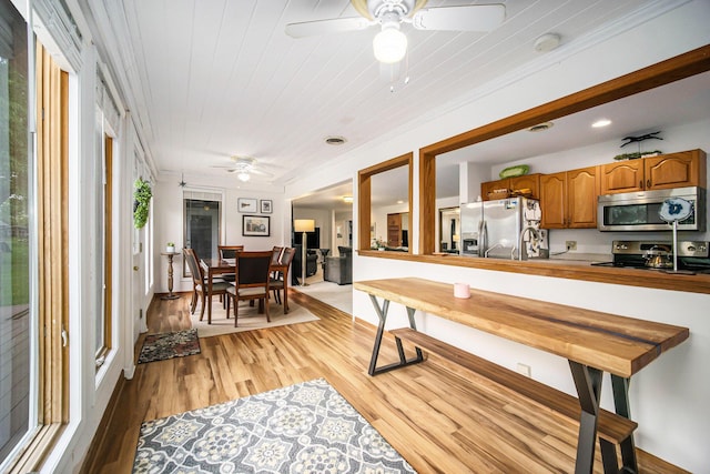55 E Lewis Ave, Milan, MI 48160 - kitchen featuring stainless steel appliances, a ceiling fan, light wood-type flooring, brown cabinets, and recessed lighting