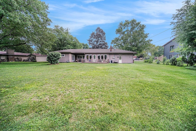 55 E Lewis Ave, Milan, MI 48160 - rear view of house with a yard and a chimney