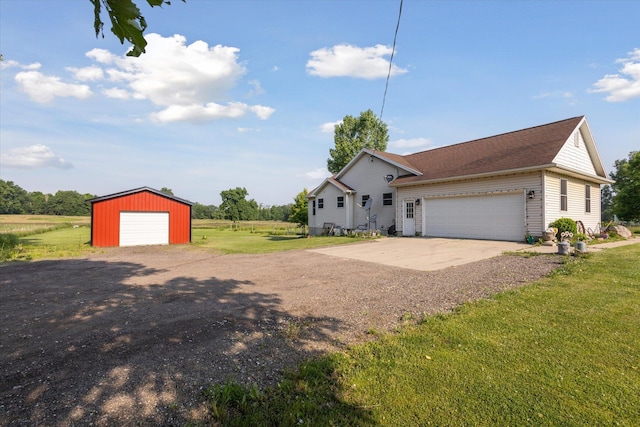 8078 S Royston Rd, Eaton Rapids, MI 48827 - view of front of property featuring a front lawn, driveway, an outdoor structure, and a detached garage