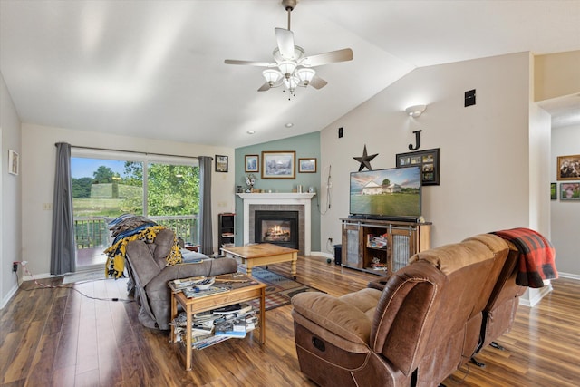 8078 S Royston Rd, Eaton Rapids, MI 48827 - living room with lofted ceiling, wood finished floors, a tiled fireplace, and ceiling fan