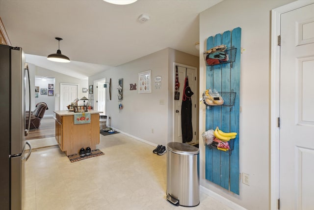 8078 S Royston Rd, Eaton Rapids, MI 48827 - kitchen with freestanding refrigerator, a center island, light countertops, lofted ceiling, and decorative light fixtures