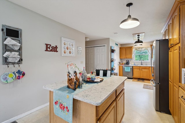 8078 S Royston Rd, Eaton Rapids, MI 48827 - kitchen with appliances with stainless steel finishes, a kitchen island, pendant lighting, and brown cabinetry