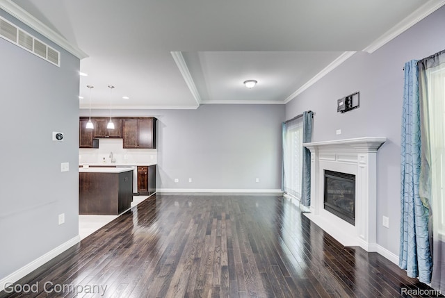 1724 Barrington Ct, Lake Orion, MI 48360 - unfurnished living room featuring dark wood-style floors, ornamental molding, a glass covered fireplace, and recessed lighting