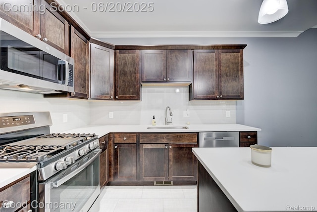 1724 Barrington Ct, Lake Orion, MI 48360 - kitchen with stainless steel appliances, crown molding, dark brown cabinetry, light countertops, and tasteful backsplash