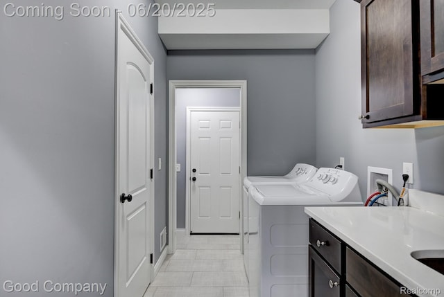 1724 Barrington Ct, Lake Orion, MI 48360 - laundry room with cabinet space, washing machine and dryer, and light tile patterned floors