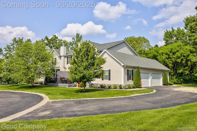 1724 Barrington Ct, Lake Orion, MI 48360 - view of property exterior featuring a garage, a chimney, a lawn, and driveway