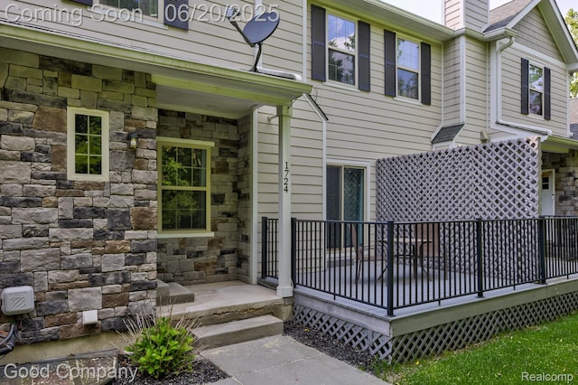 1724 Barrington Ct, Lake Orion, MI 48360 - doorway to property with stone siding, a chimney, and a deck