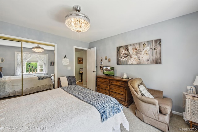 12132 Lexington Dr Unit 2, South Lyon, MI 48178 - carpeted bedroom with a chandelier, a closet, and baseboards