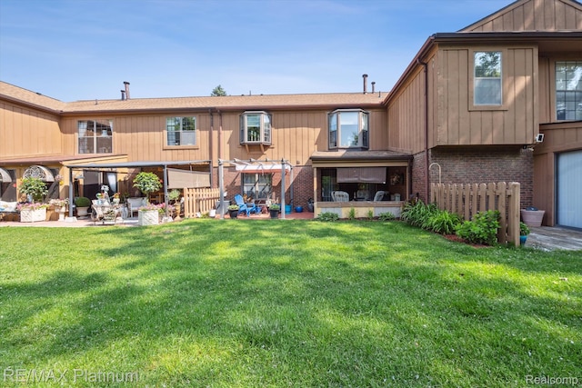 12132 Lexington Dr Unit 2, South Lyon, MI 48178 - back of house featuring brick siding, a patio, and a yard