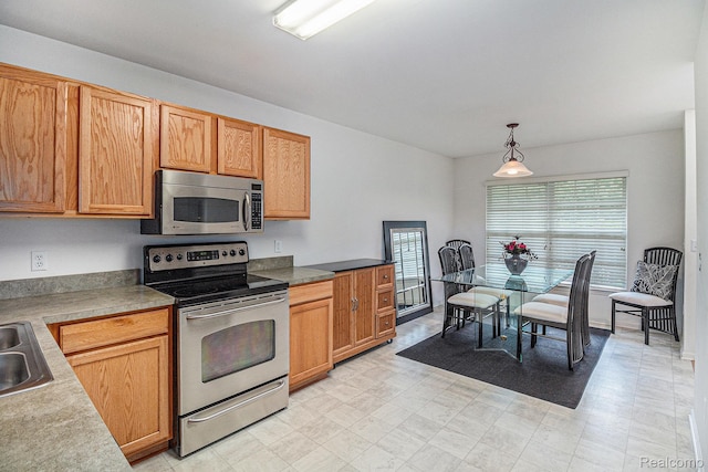 5891 Augusta Ln, Grand Blanc, MI 48439 - kitchen featuring stainless steel appliances, hanging light fixtures, light floors, and light countertops