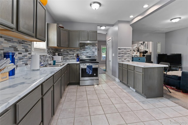 15 Forest St, River Rouge, MI 48218 - kitchen with stainless steel range, light tile patterned floors, backsplash, open floor plan, and light stone countertops