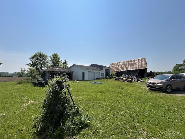 4764 9 Mile Rd, Pinconning, MI 48650 - view of grassy yard with an outdoor structure