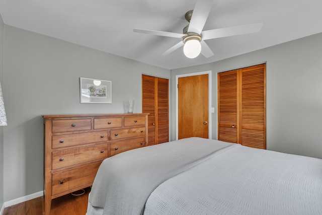 3622 Cushing Ct, Dexter, MI 48130 - bedroom featuring wood finished floors, multiple closets, baseboards, and a ceiling fan