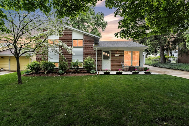 3622 Cushing Ct, Dexter, MI 48130 - view of front of property with a front lawn, brick siding, and driveway