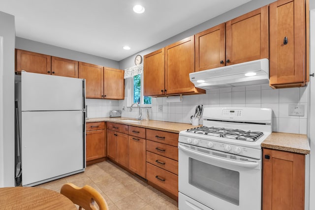 3622 Cushing Ct, Dexter, MI 48130 - kitchen featuring white appliances, under cabinet range hood, decorative backsplash, a sink, and brown cabinetry