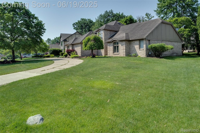 30753 Sunderland Dr, Farmington Hills, MI 48331 - view of front facade featuring a front yard, board and batten siding, and brick siding