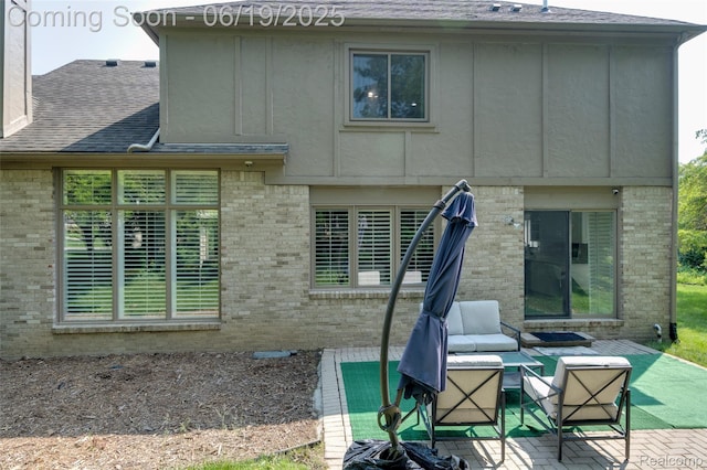 30753 Sunderland Dr, Farmington Hills, MI 48331 - back of house with brick siding, a shingled roof, and an outdoor hangout area