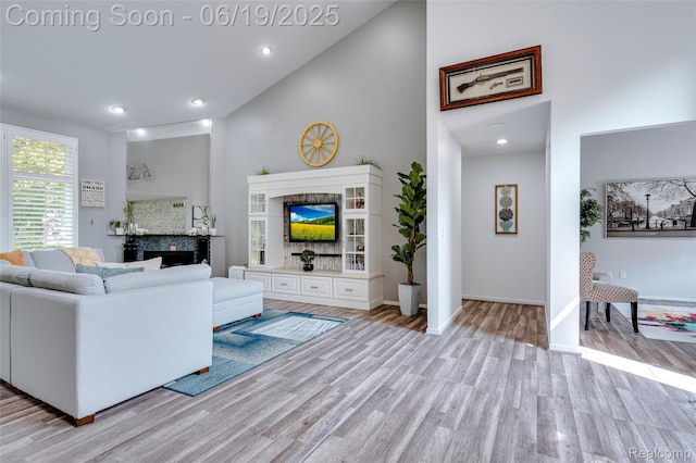 30753 Sunderland Dr, Farmington Hills, MI 48331 - living area featuring high vaulted ceiling, light wood-style floors, recessed lighting, and a fireplace