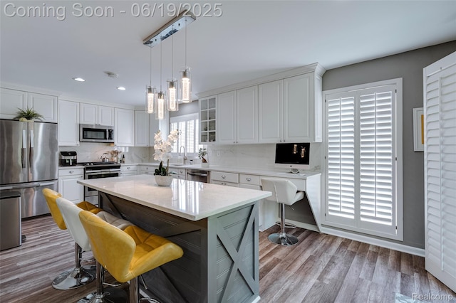 30753 Sunderland Dr, Farmington Hills, MI 48331 - kitchen with appliances with stainless steel finishes, white cabinetry, backsplash, recessed lighting, and decorative light fixtures
