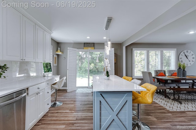 30753 Sunderland Dr, Farmington Hills, MI 48331 - kitchen with stainless steel dishwasher, white cabinetry, dark wood-style flooring, a kitchen breakfast bar, and recessed lighting