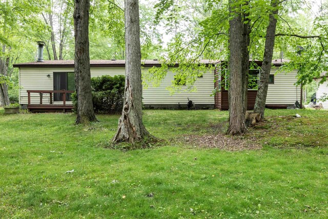 5665 N Sturgeon Rd, Midland, MI 48624 - view of grassy yard with a wooden deck