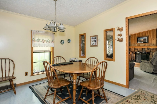 5665 N Sturgeon Rd, Midland, MI 48624 - dining room with ornamental molding, a textured ceiling, a chandelier, baseboards, and a fireplace